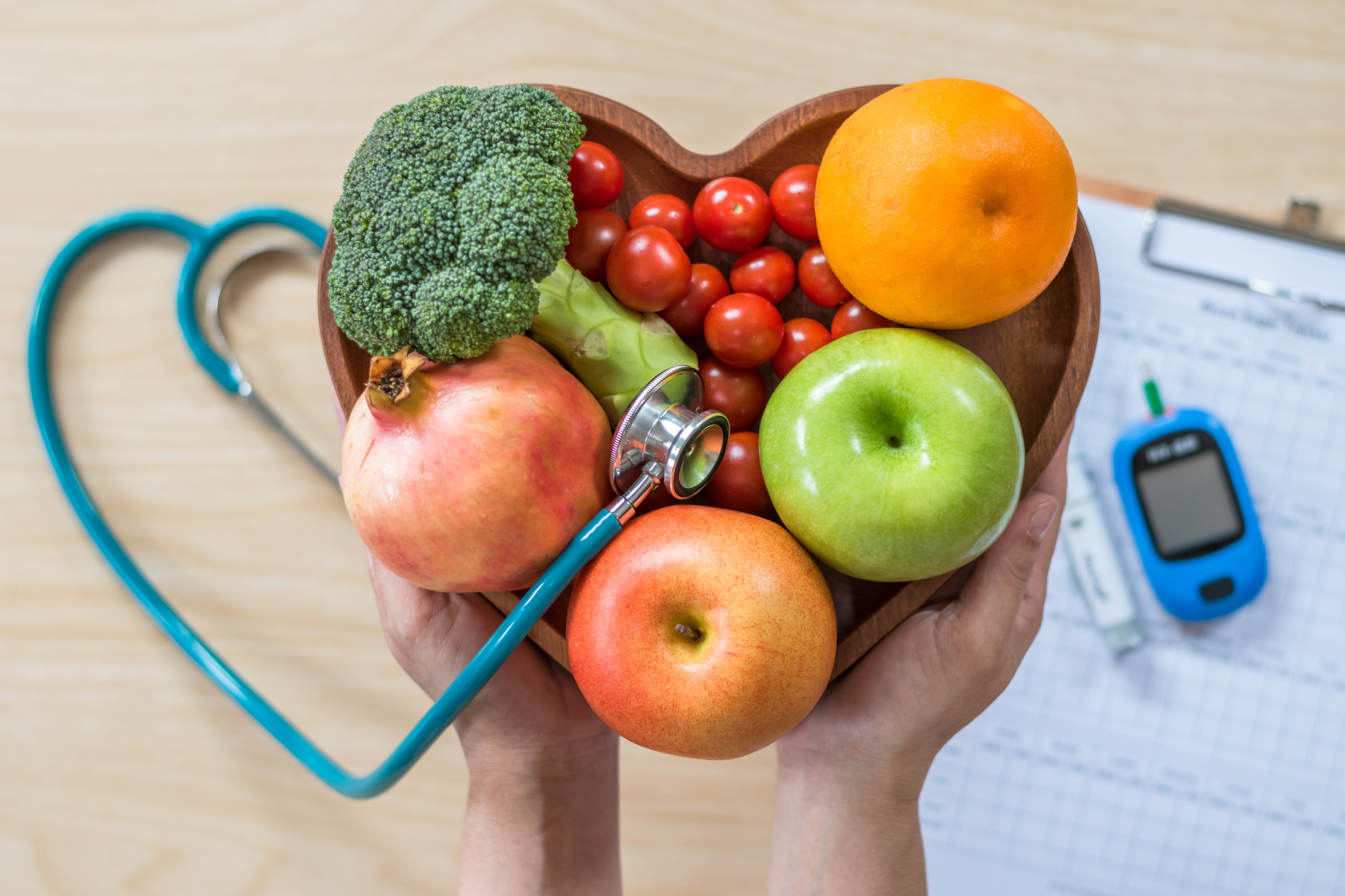 heart shaped bowl of fruits and vegetables