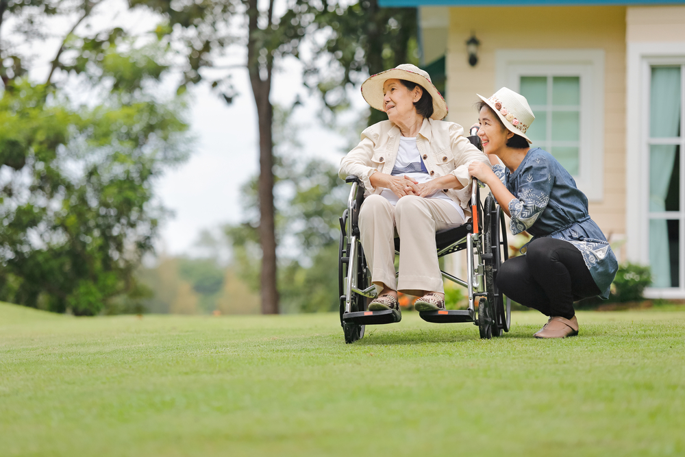 woman in a wheelchair with caregiver