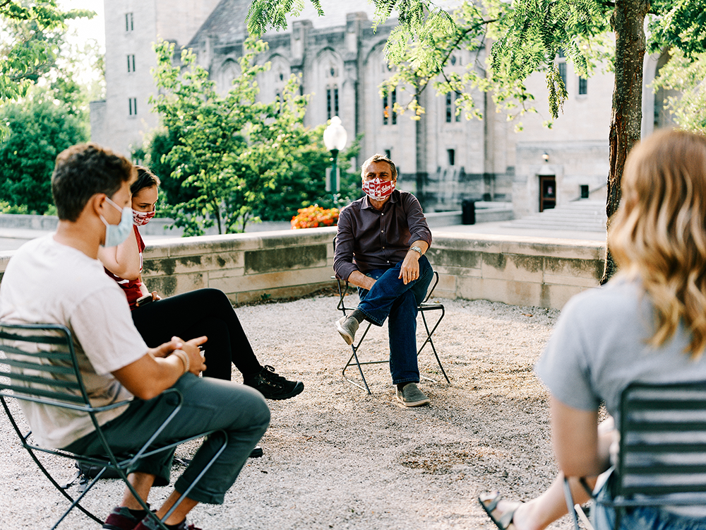 group sitting in circle talking with masks on