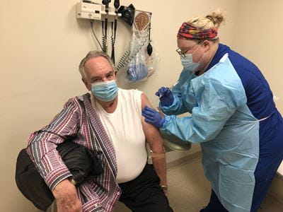 oe Morris gets a shot during AstraZeneca COVID-19 vaccine study